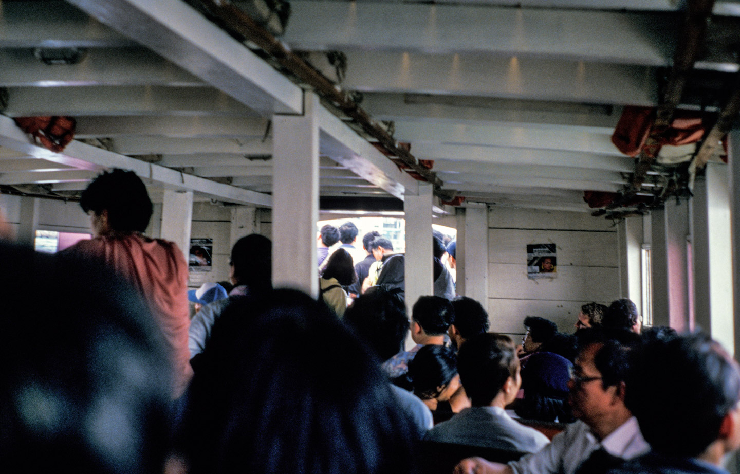 Inside a small wooden ferryboat, full of Chinese people