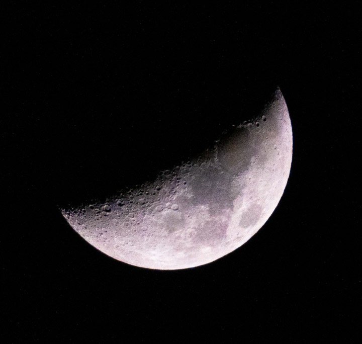 Photograph of the moon, half-shadowed